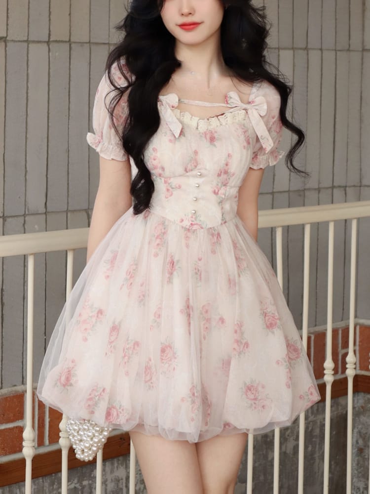 Whimsical and light, this floral mini dress is a fairytale in fabric. The dreamy puff sleeves and delicate pink flowers create a romantic silhouette perfect for any occasion.