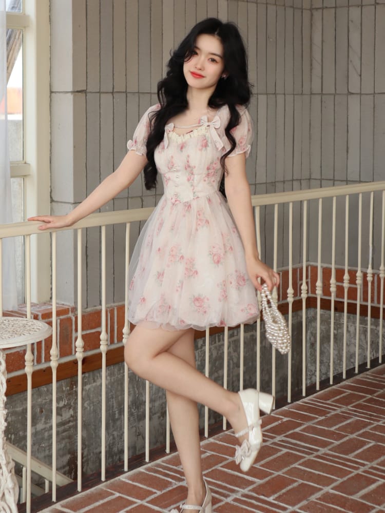 Whimsical and light, this floral mini dress is a fairytale in fabric. The dreamy puff sleeves and delicate pink flowers create a romantic silhouette perfect for any occasion.